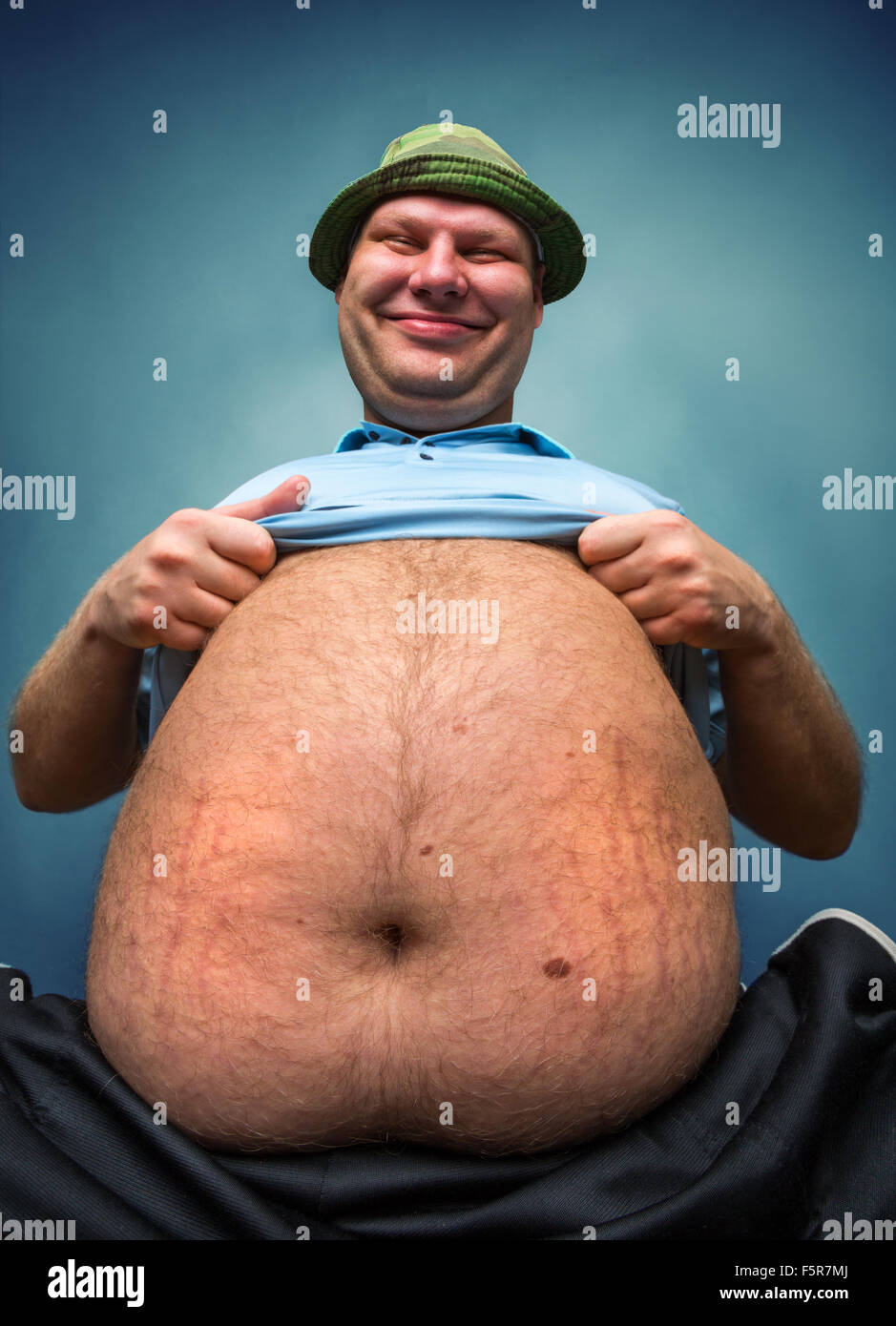 very-fat-man-demonstrate-his-big-belly-F5R7MJ.jpg